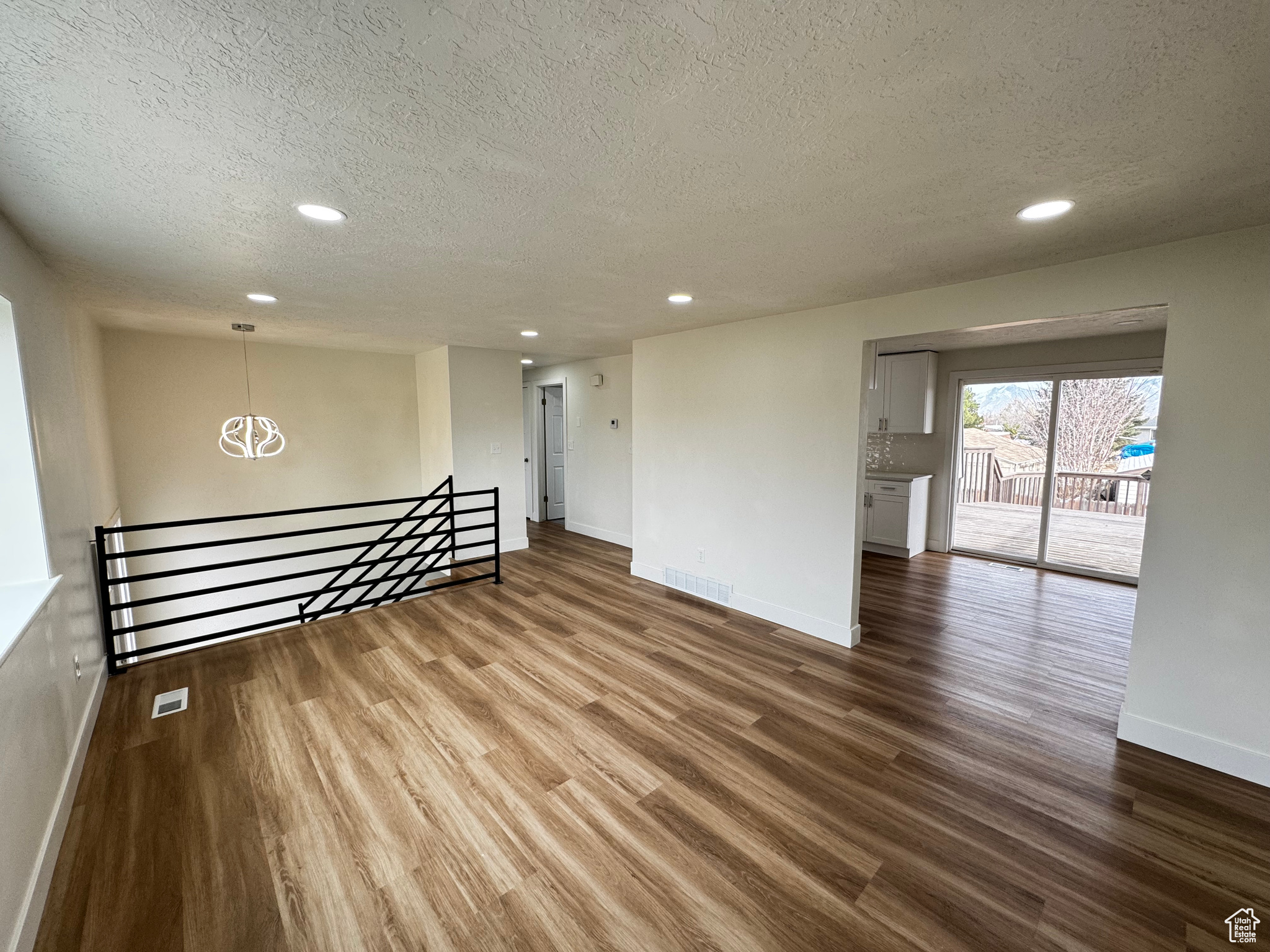 Spare room with wood-type flooring and a textured ceiling