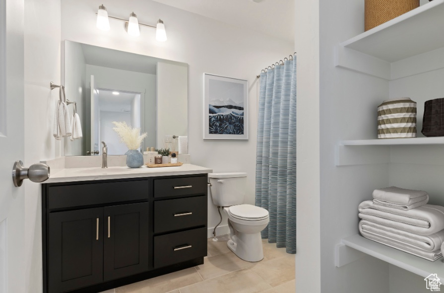 Bathroom with tile patterned flooring, vanity, and toilet