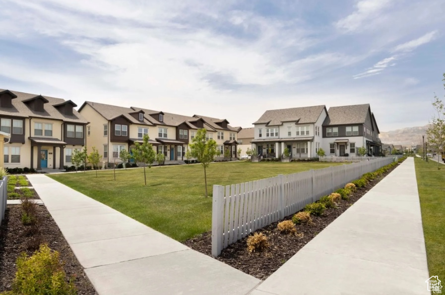 View of property's community featuring a yard