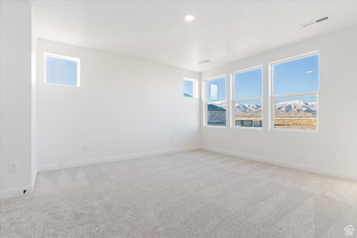 Empty room with light colored carpet