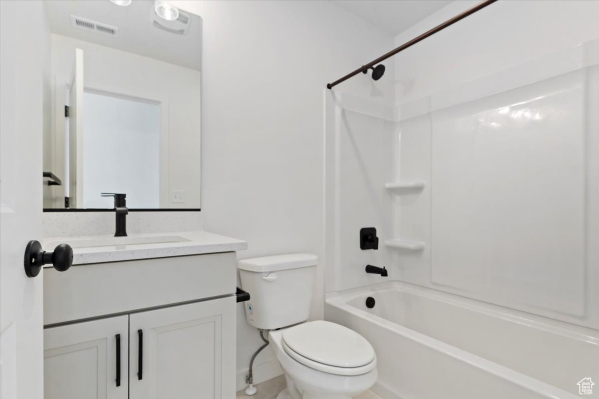 Full bathroom with vanity, shower / bathtub combination, and toilet