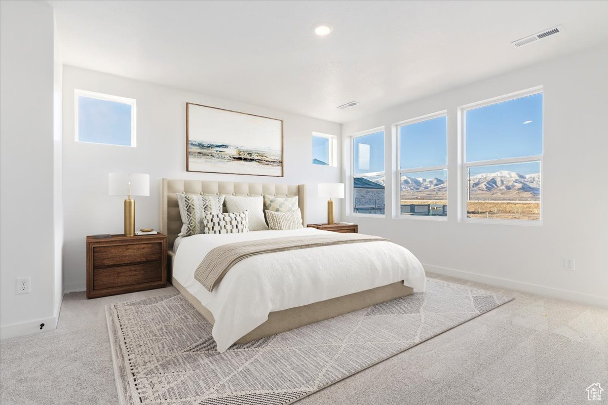 Bedroom featuring carpet flooring and a mountain view