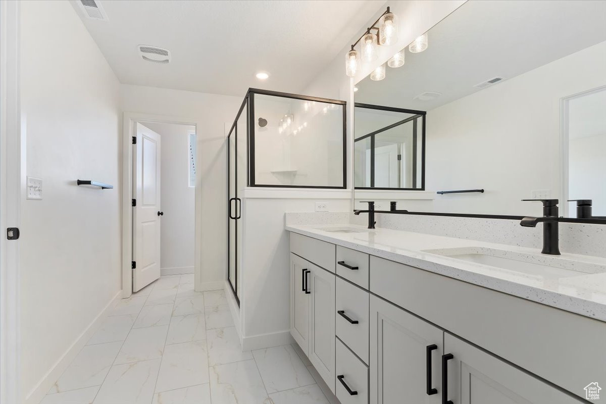 Bathroom featuring vanity and an enclosed shower