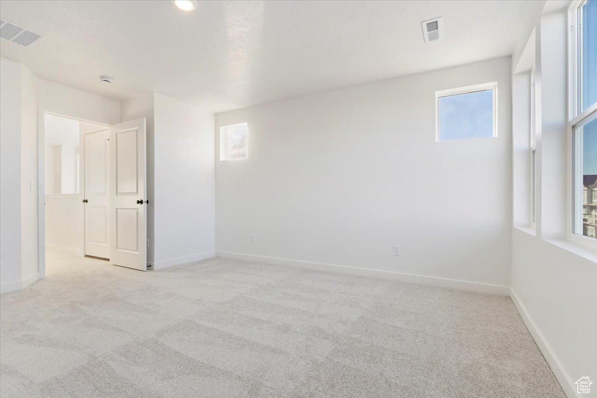 Carpeted spare room with plenty of natural light