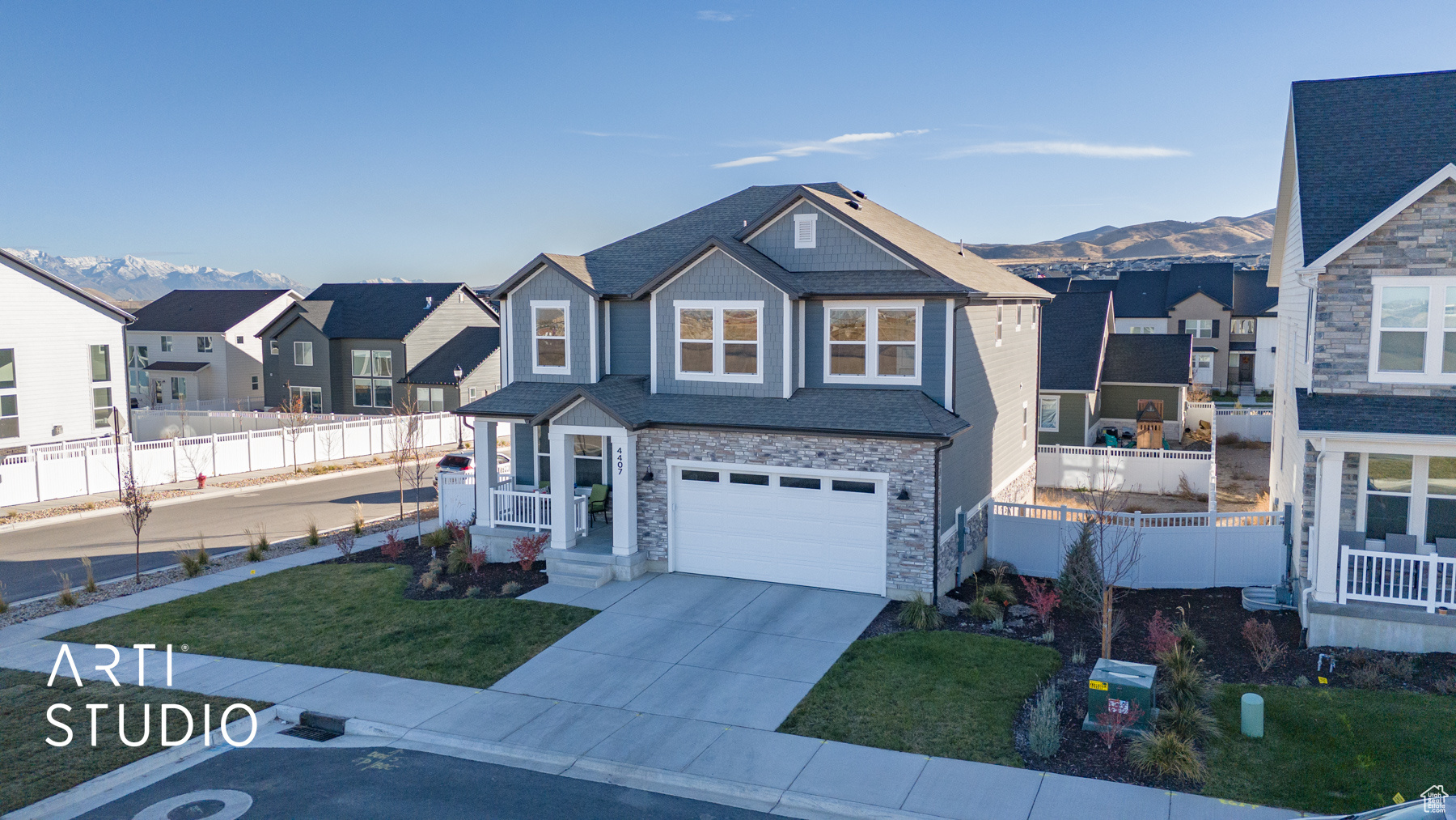 View of front of home featuring a mountain view, a garage, and a front lawn