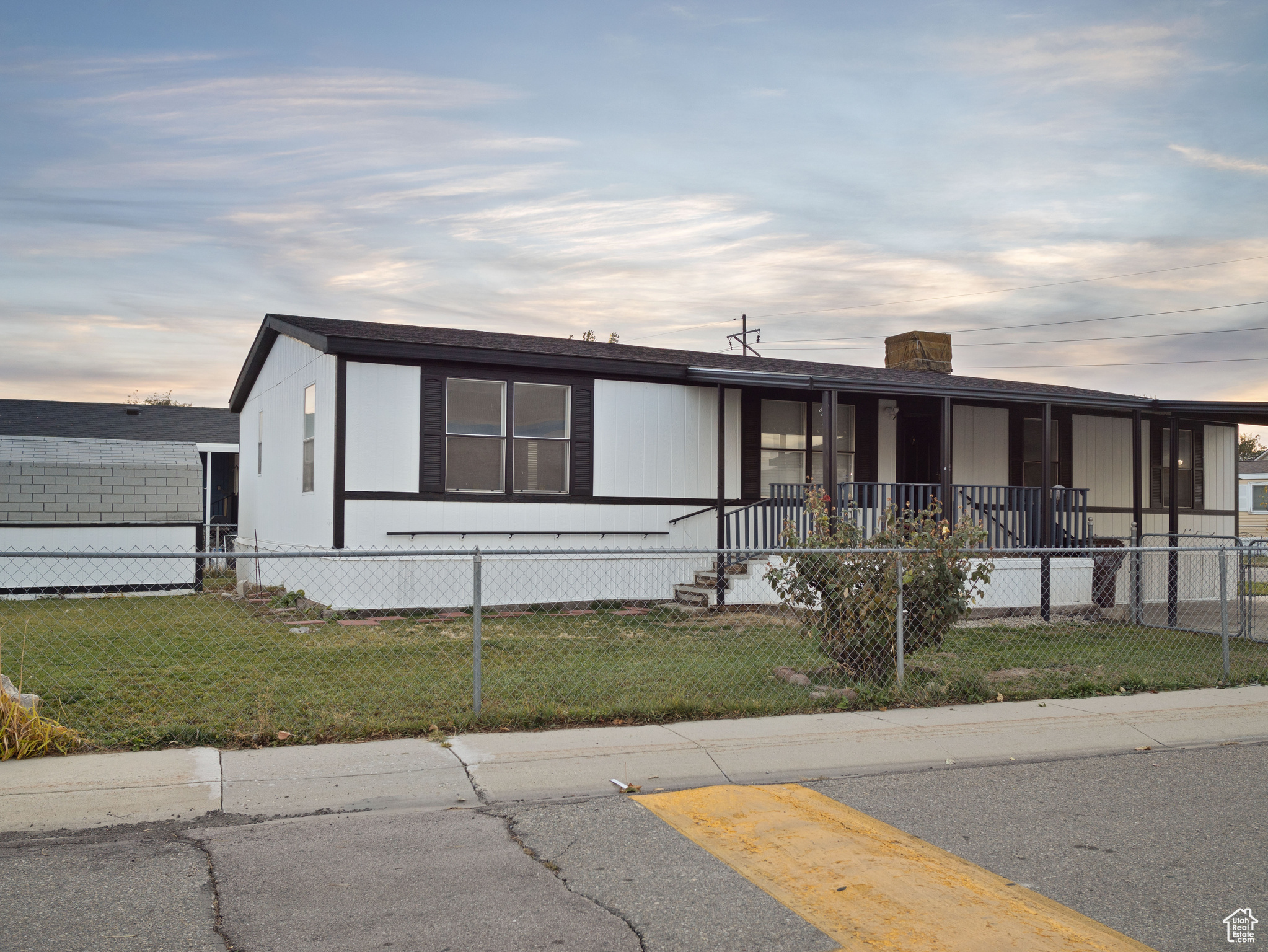 Manufactured / mobile home with a lawn and a porch