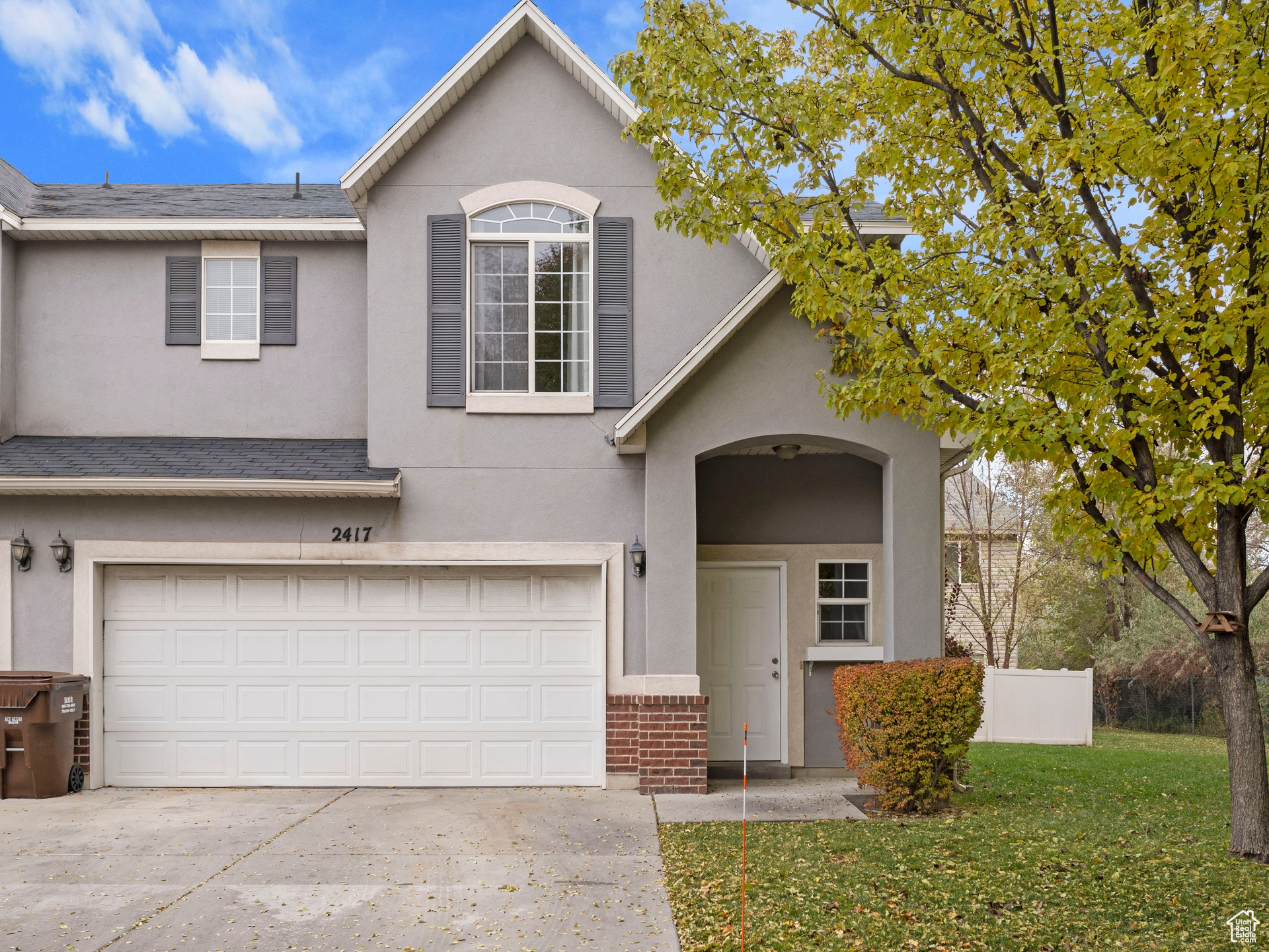 View of front facade with a front lawn and a garage