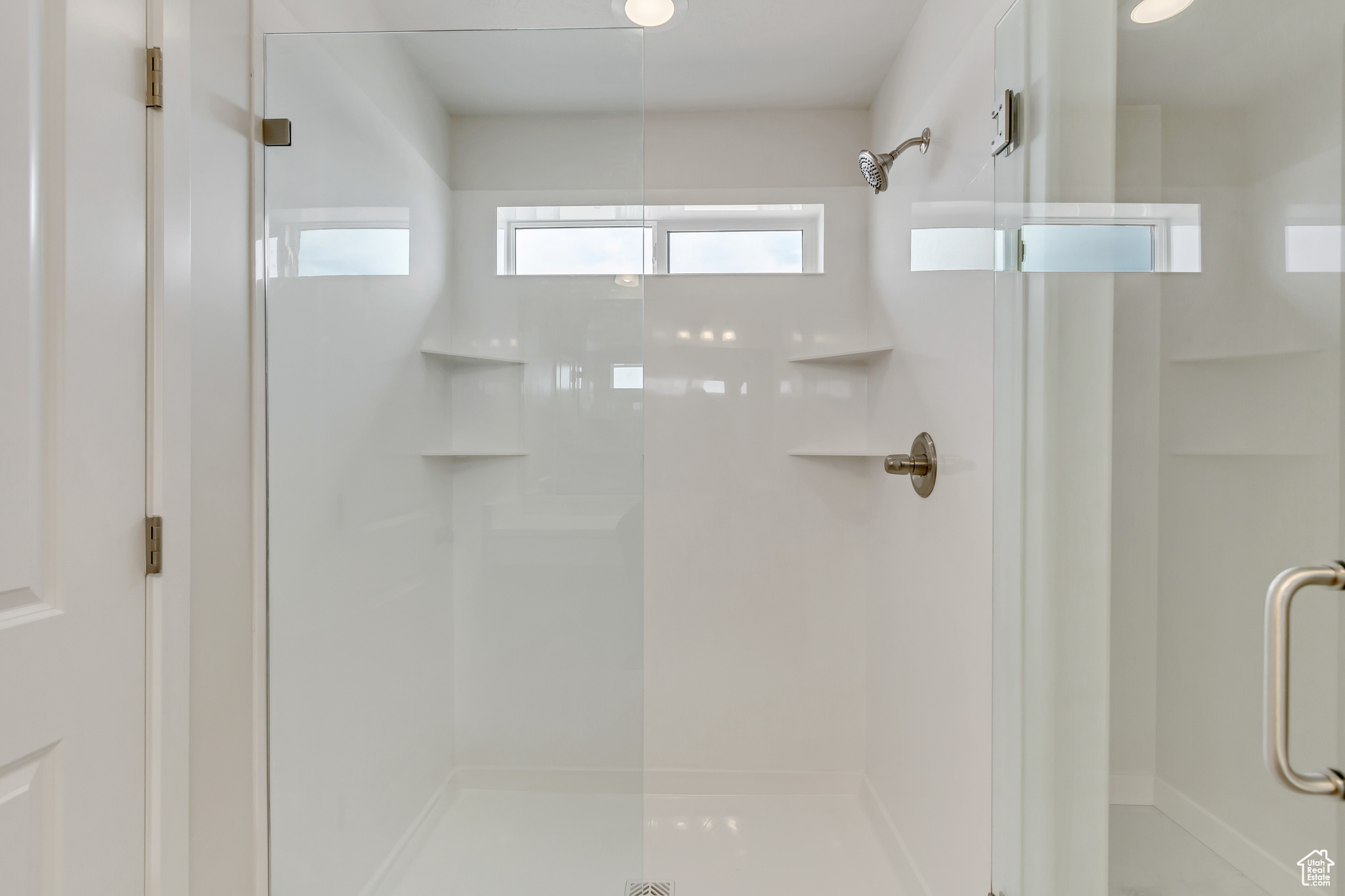 Bathroom featuring a shower with door