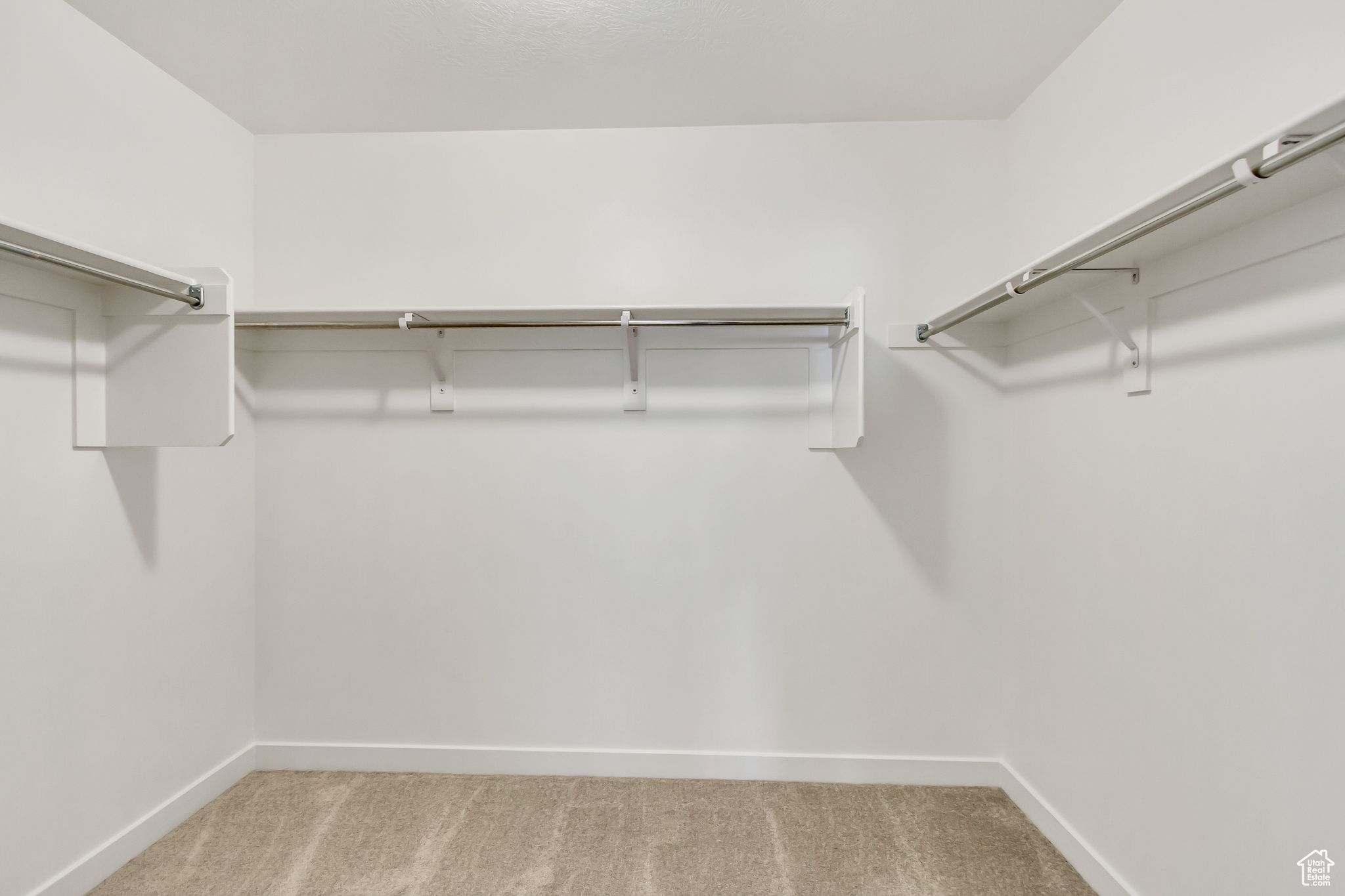 Spacious closet with light carpet