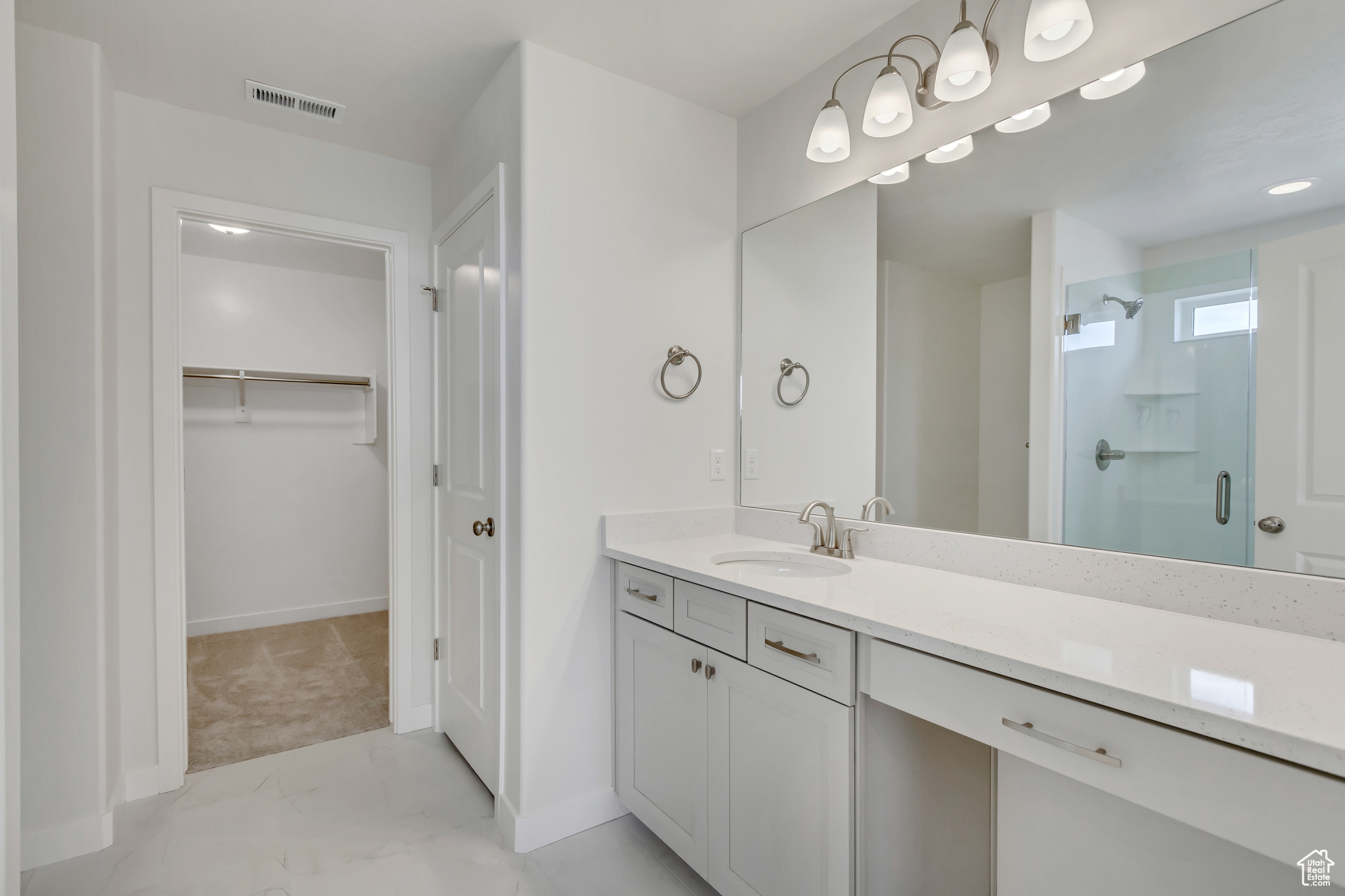 Bathroom featuring vanity and an enclosed shower