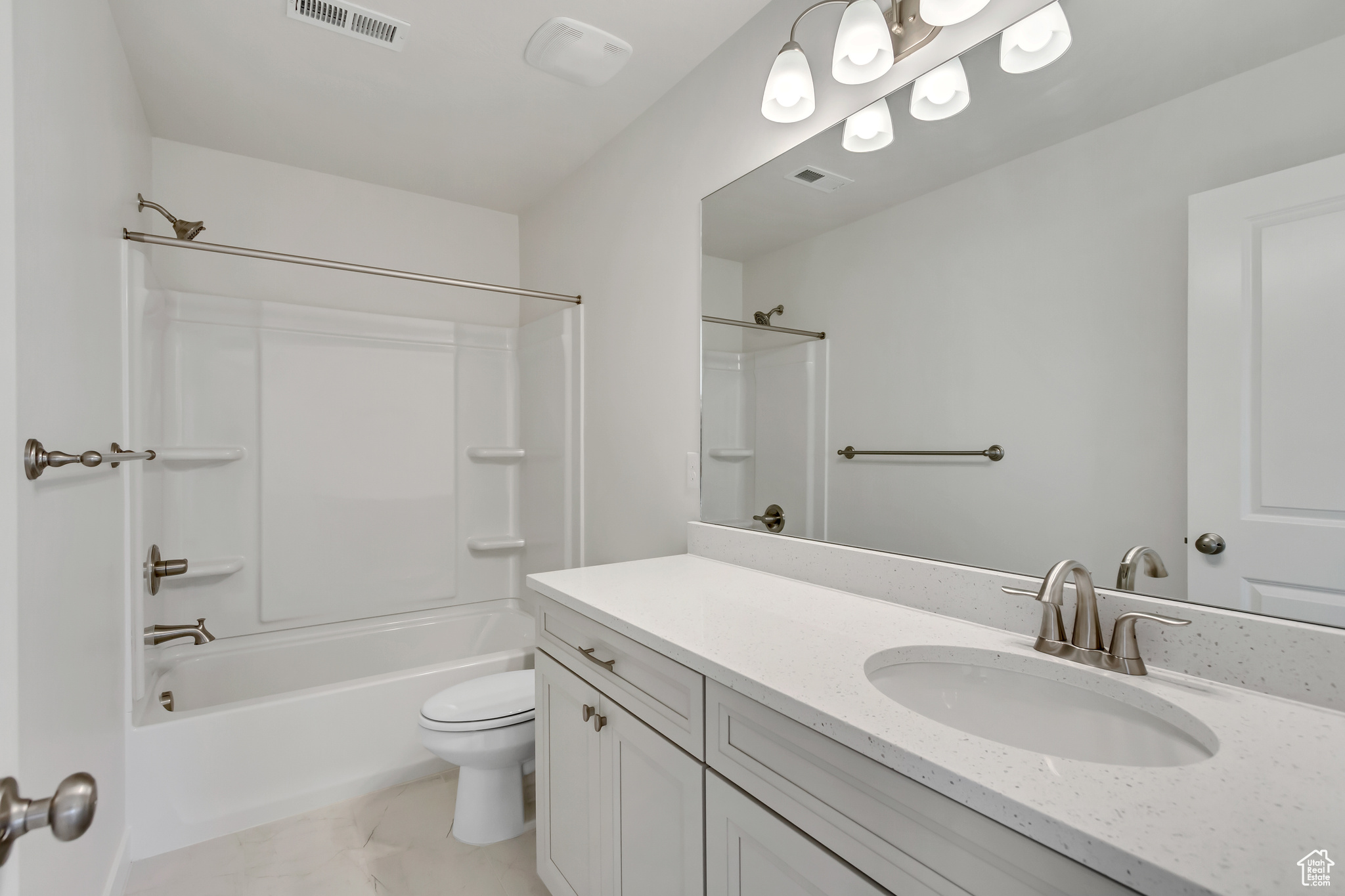 Full bathroom featuring toilet, vanity, and bathing tub / shower combination