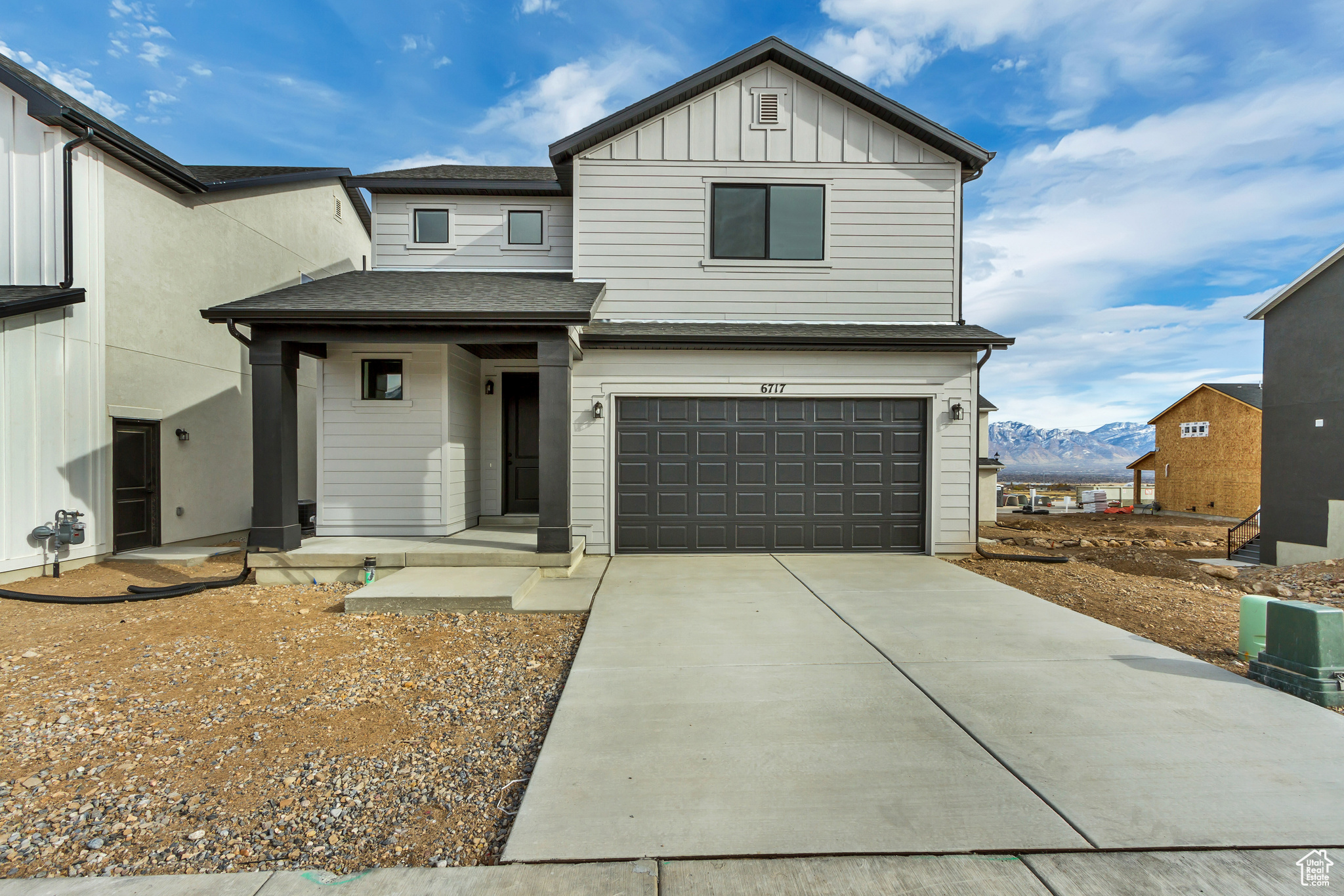 View of front of property with a mountain view and a garage