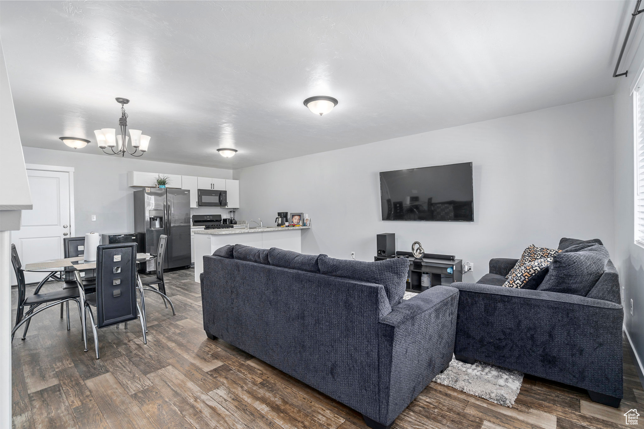 Living room featuring dark hardwood / wood-style floors and an inviting chandelier