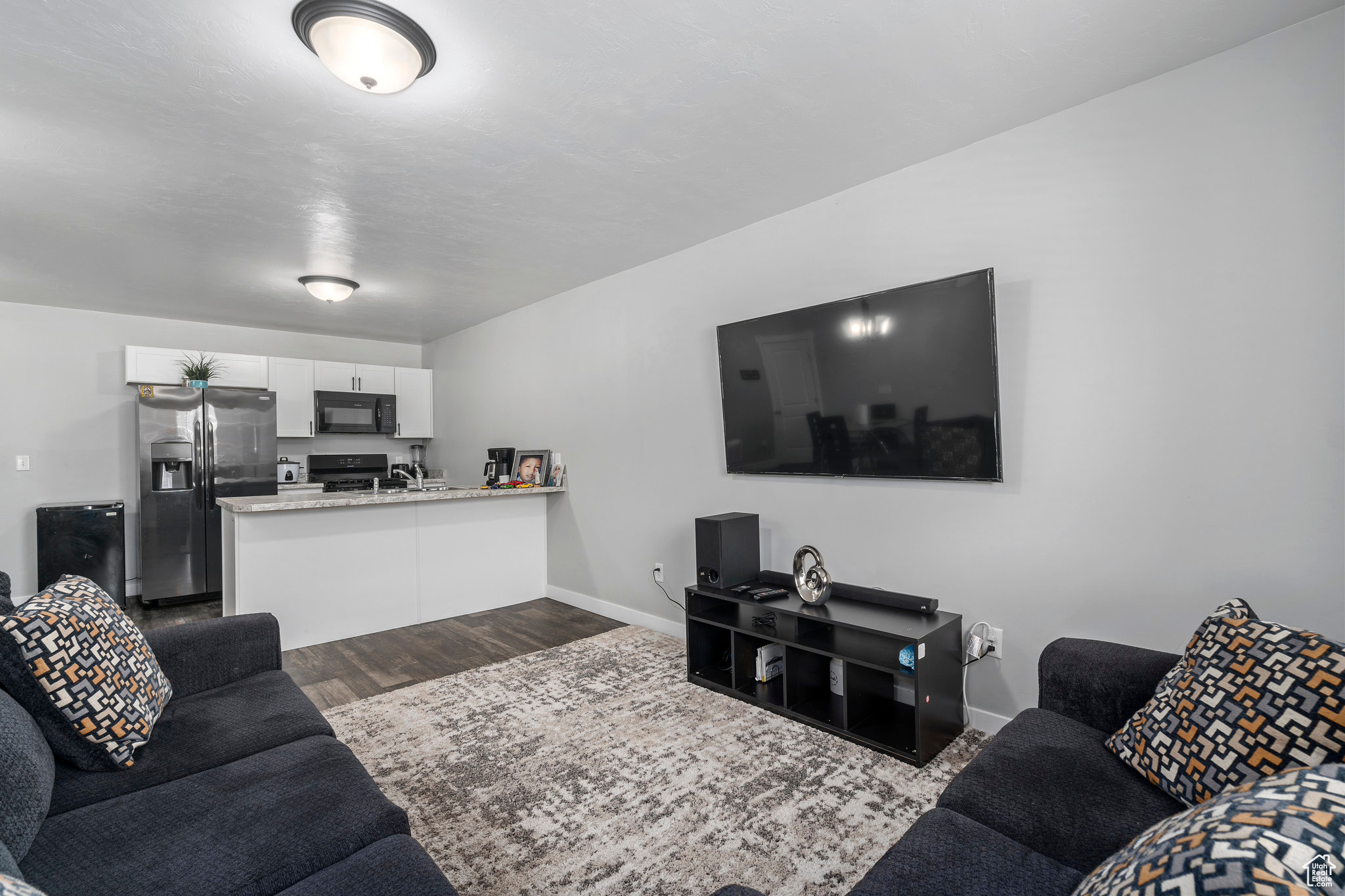 Living room with dark hardwood / wood-style flooring