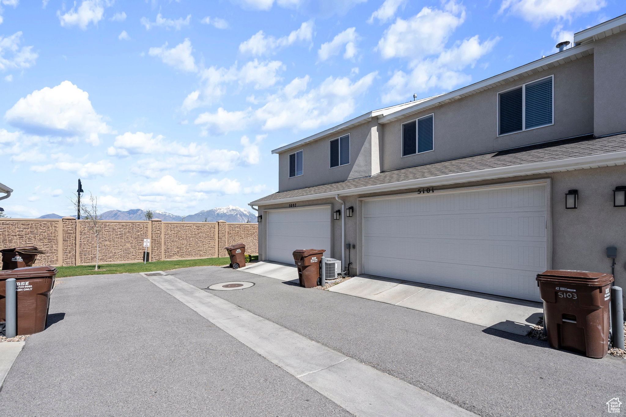 View of front of house featuring central air condition unit, a mountain view, and a garage