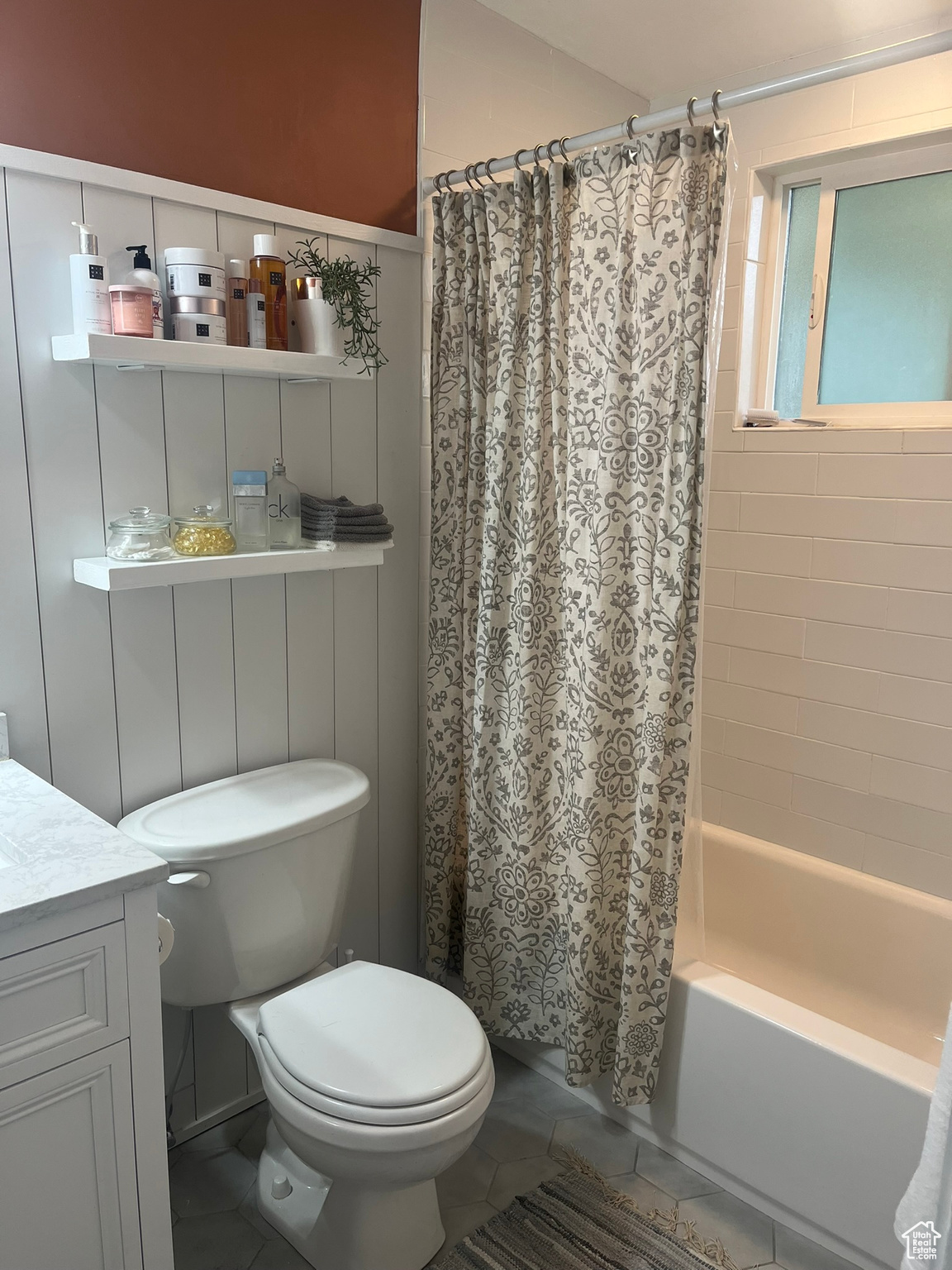 Full bathroom featuring tile patterned flooring, shower / bath combination with curtain, vanity, and toilet