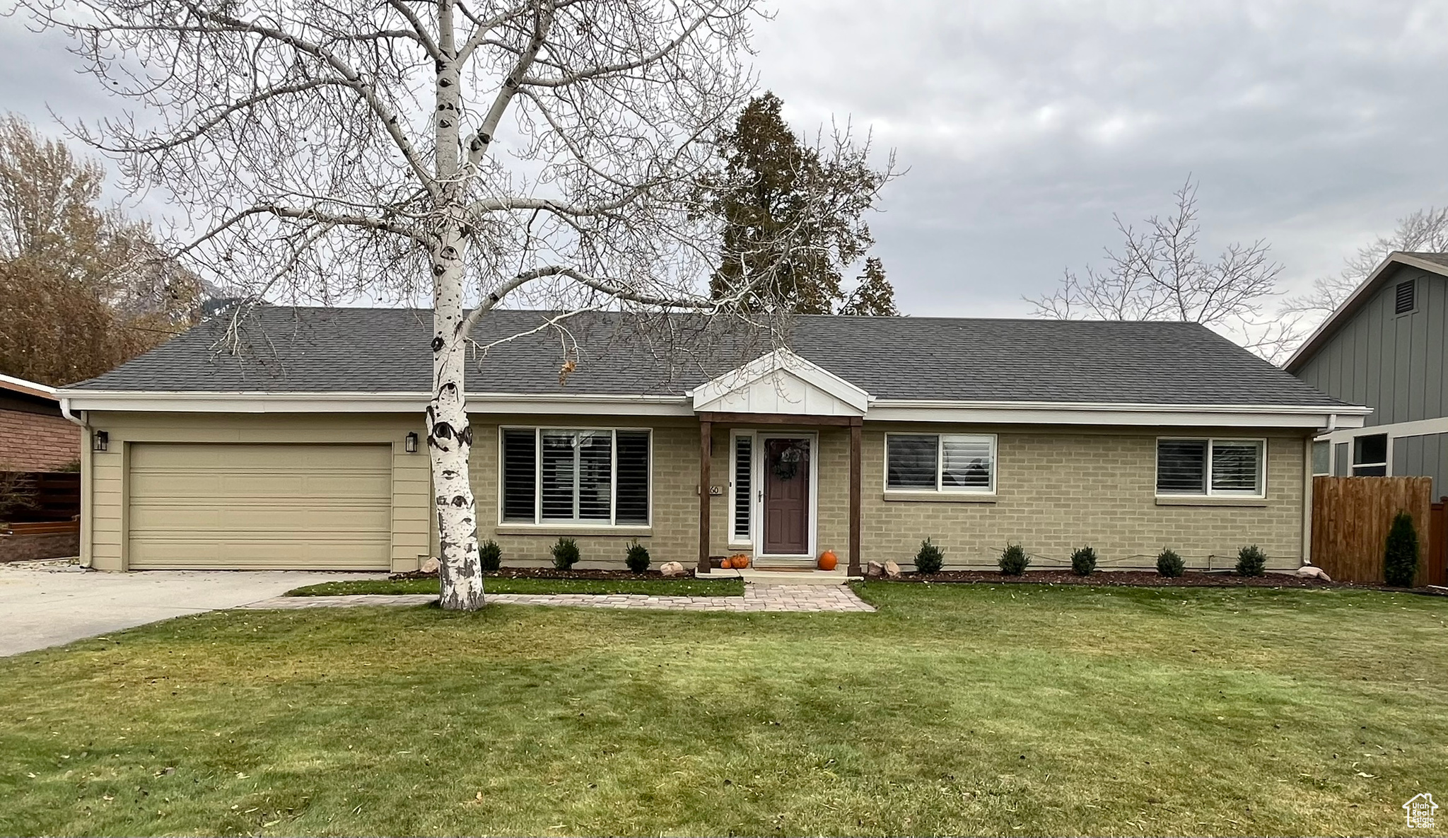 Single story home with a front yard and a garage