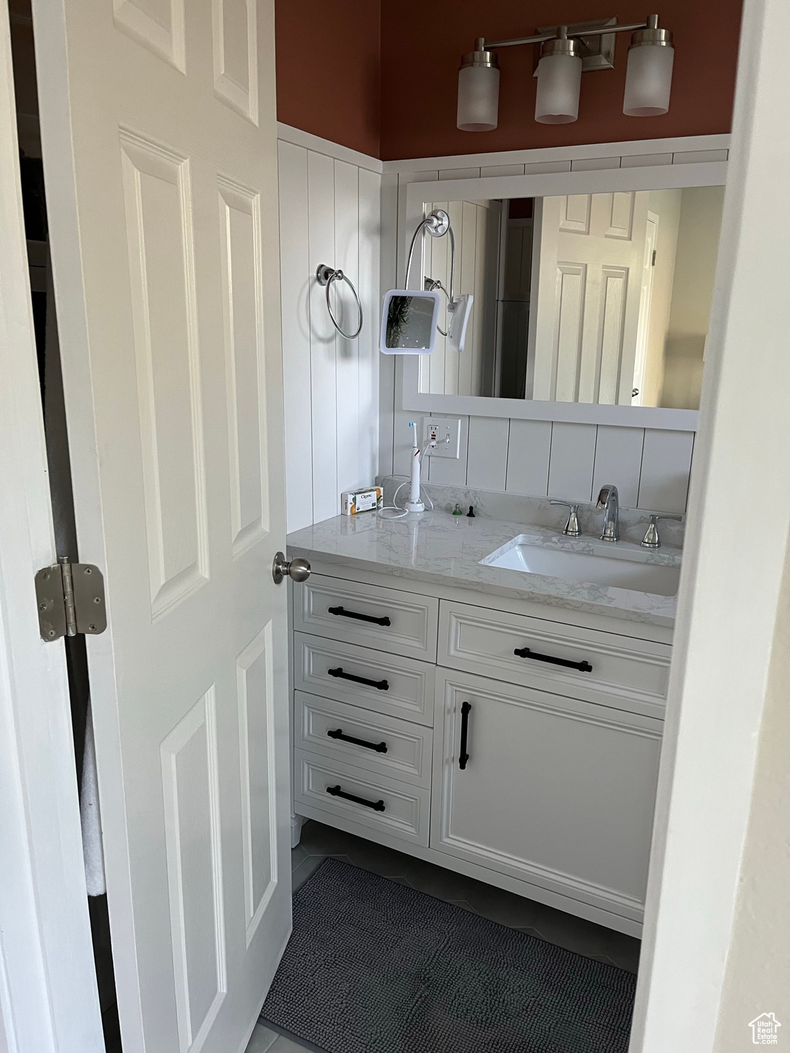 Bathroom featuring tile patterned flooring and vanity