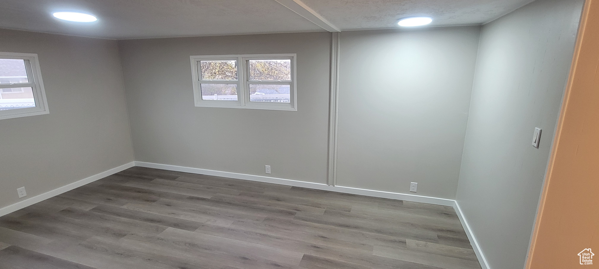 Unfurnished room featuring wood-type flooring and plenty of natural light