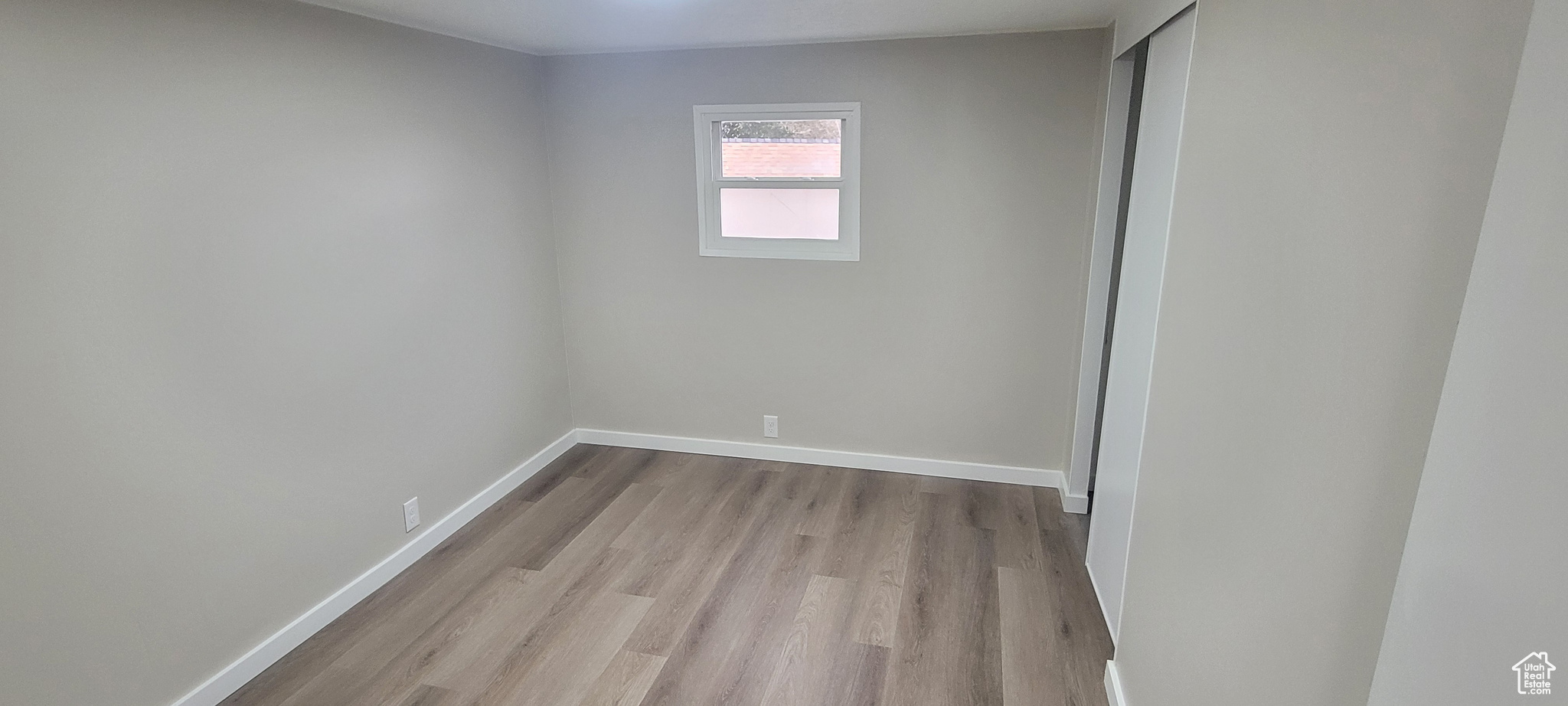 Unfurnished room with light wood-type flooring