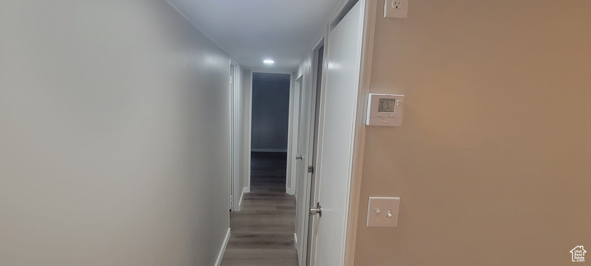 Corridor with hardwood / wood-style flooring