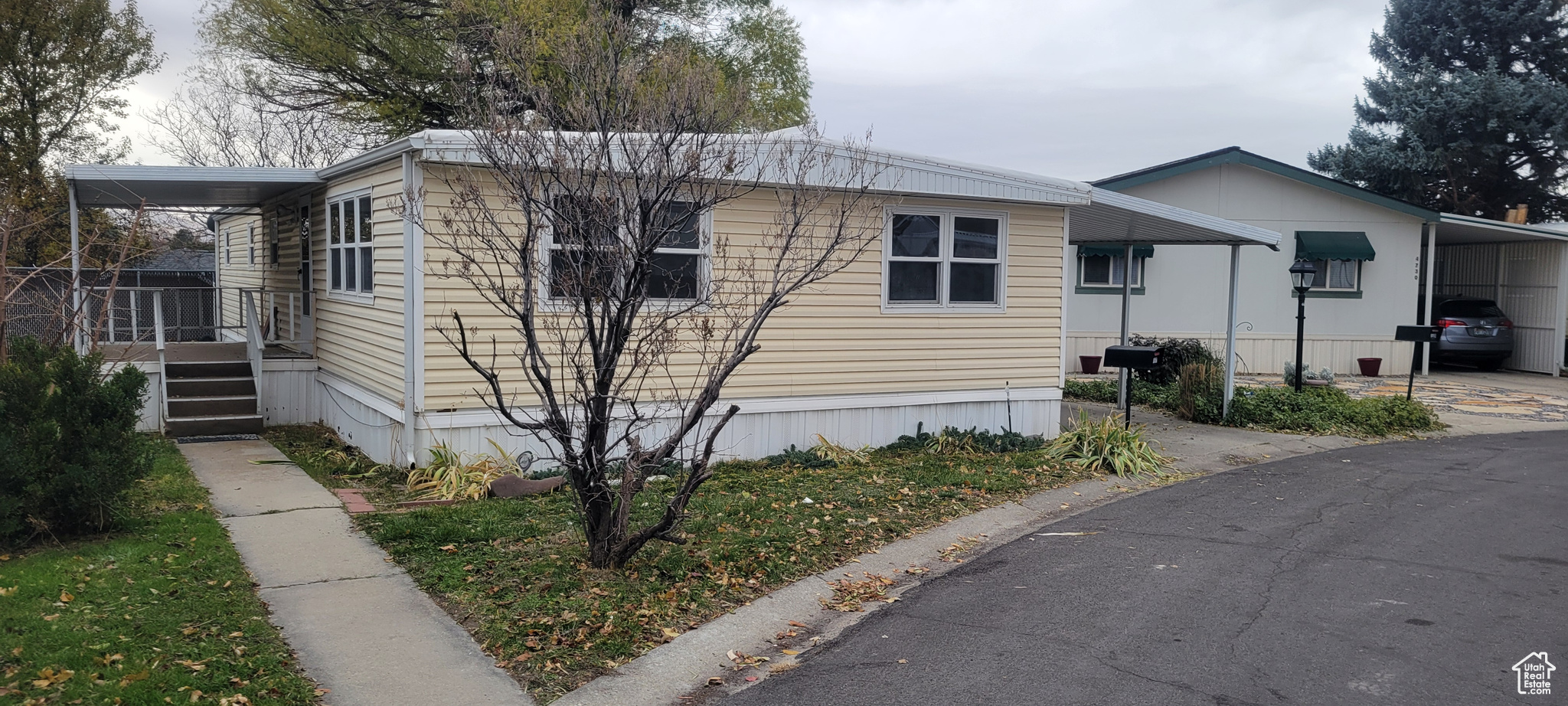 View of side of property with a carport