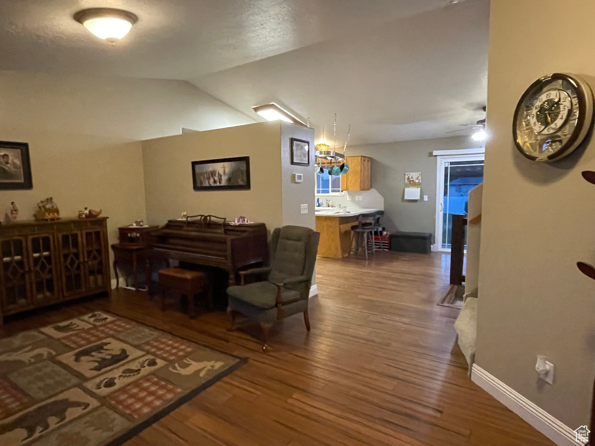 Interior space with wood-type flooring, vaulted ceiling, and ceiling fan