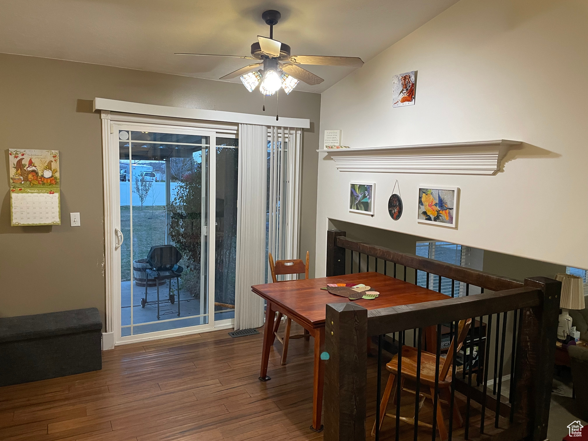 Dining area with dark hardwood / wood-style flooring, ceiling fan, and lofted ceiling