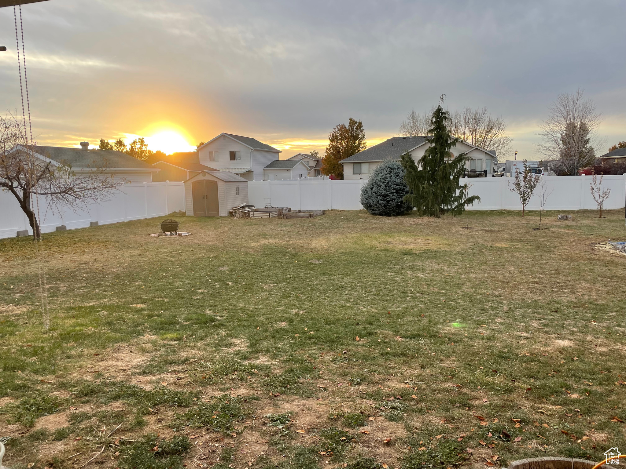 Backyard at dusk with a storage shed