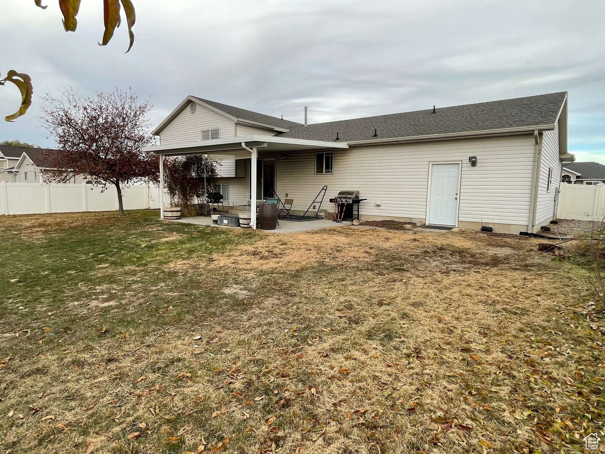 Back of house featuring a lawn and a covered patio area