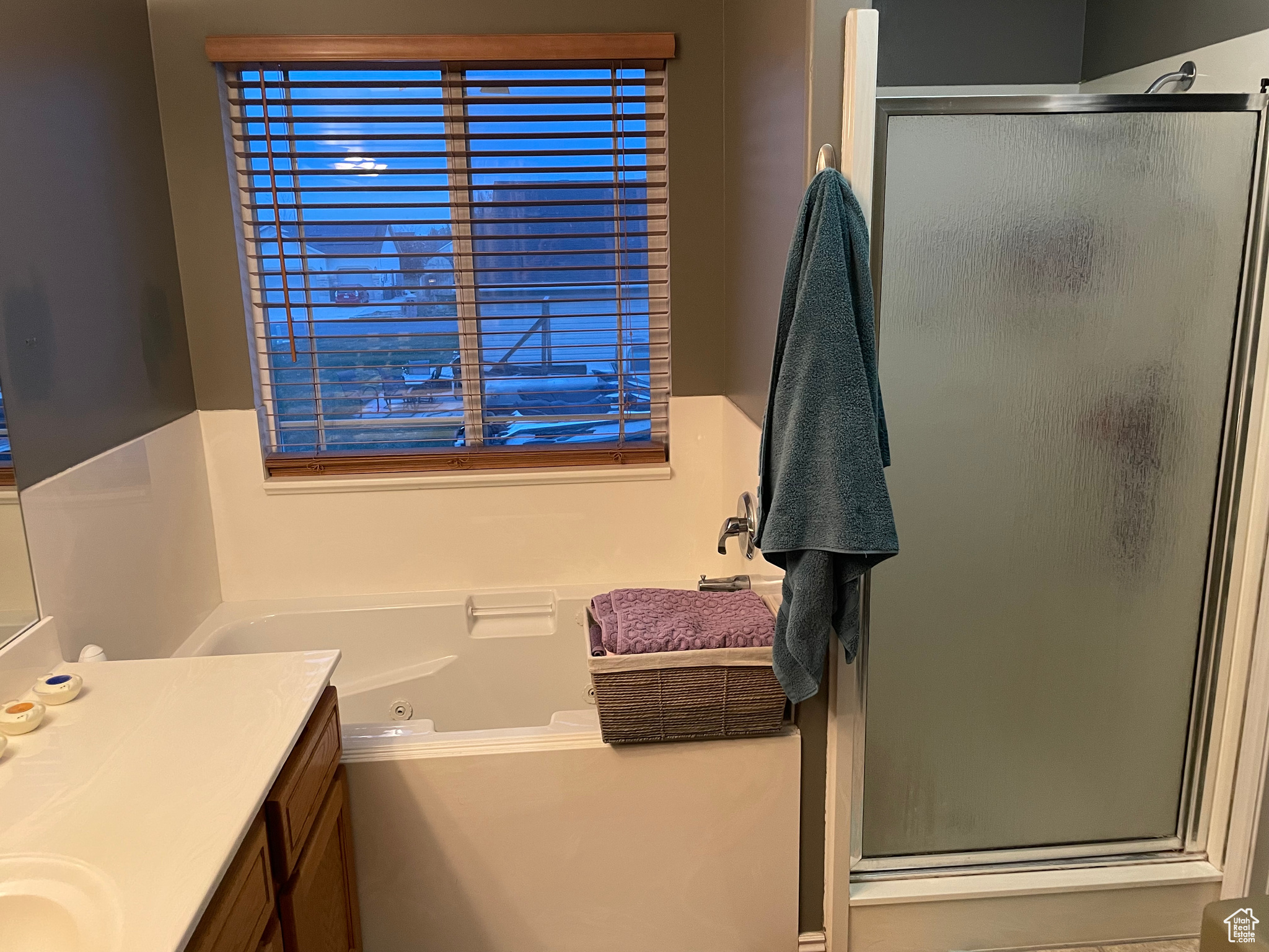 Bathroom featuring vanity and shower with separate bathtub