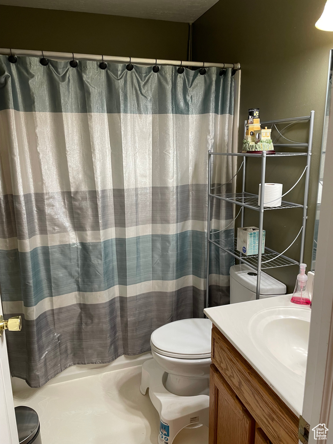 Bathroom with a shower with shower curtain, vanity, and toilet