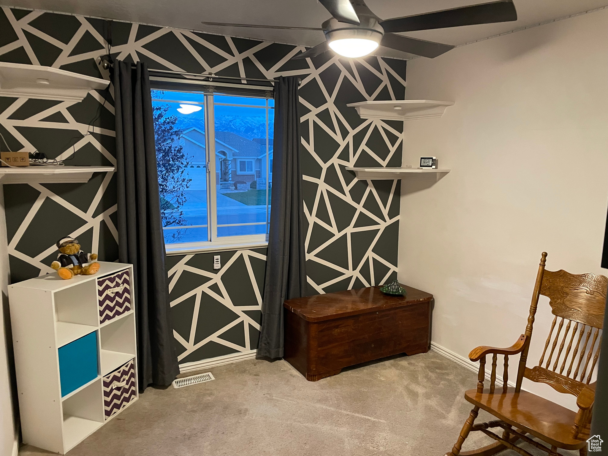 Interior space with ceiling fan and carpet