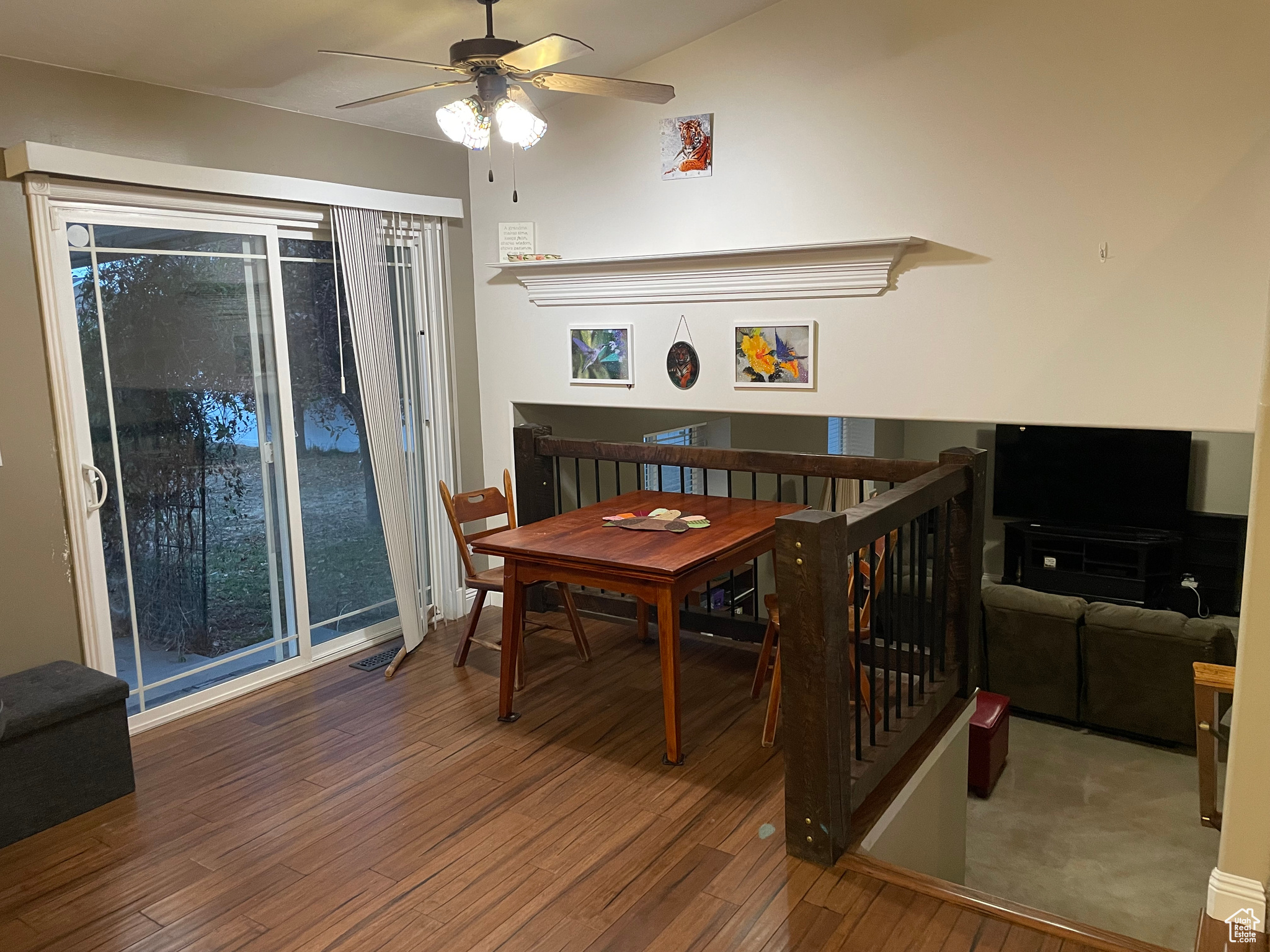 Dining area with hardwood / wood-style flooring and ceiling fan