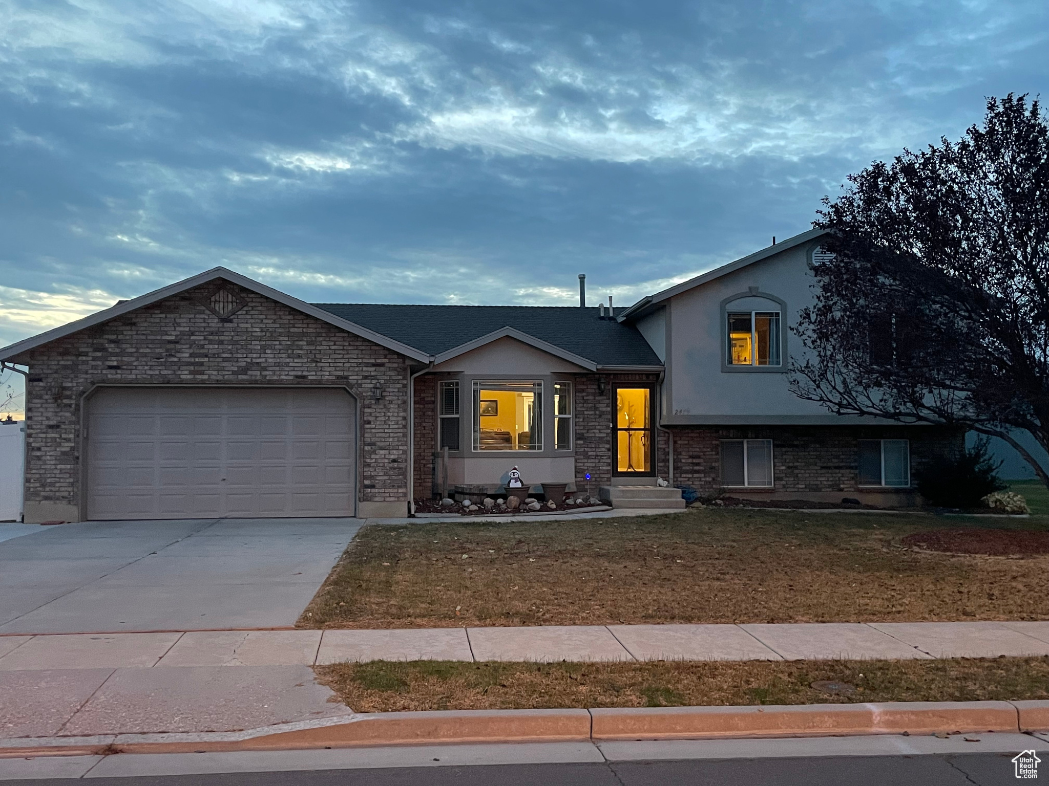 View of front of home featuring a garage and a front yard