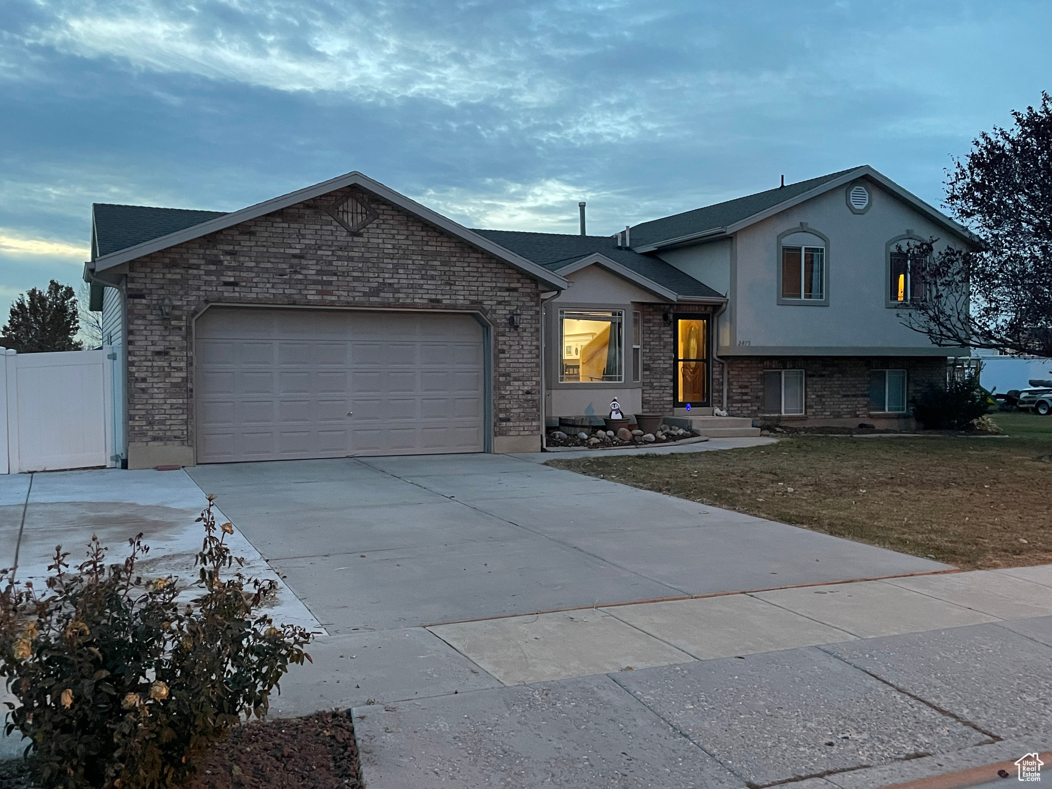 Split level home featuring a garage and a front yard