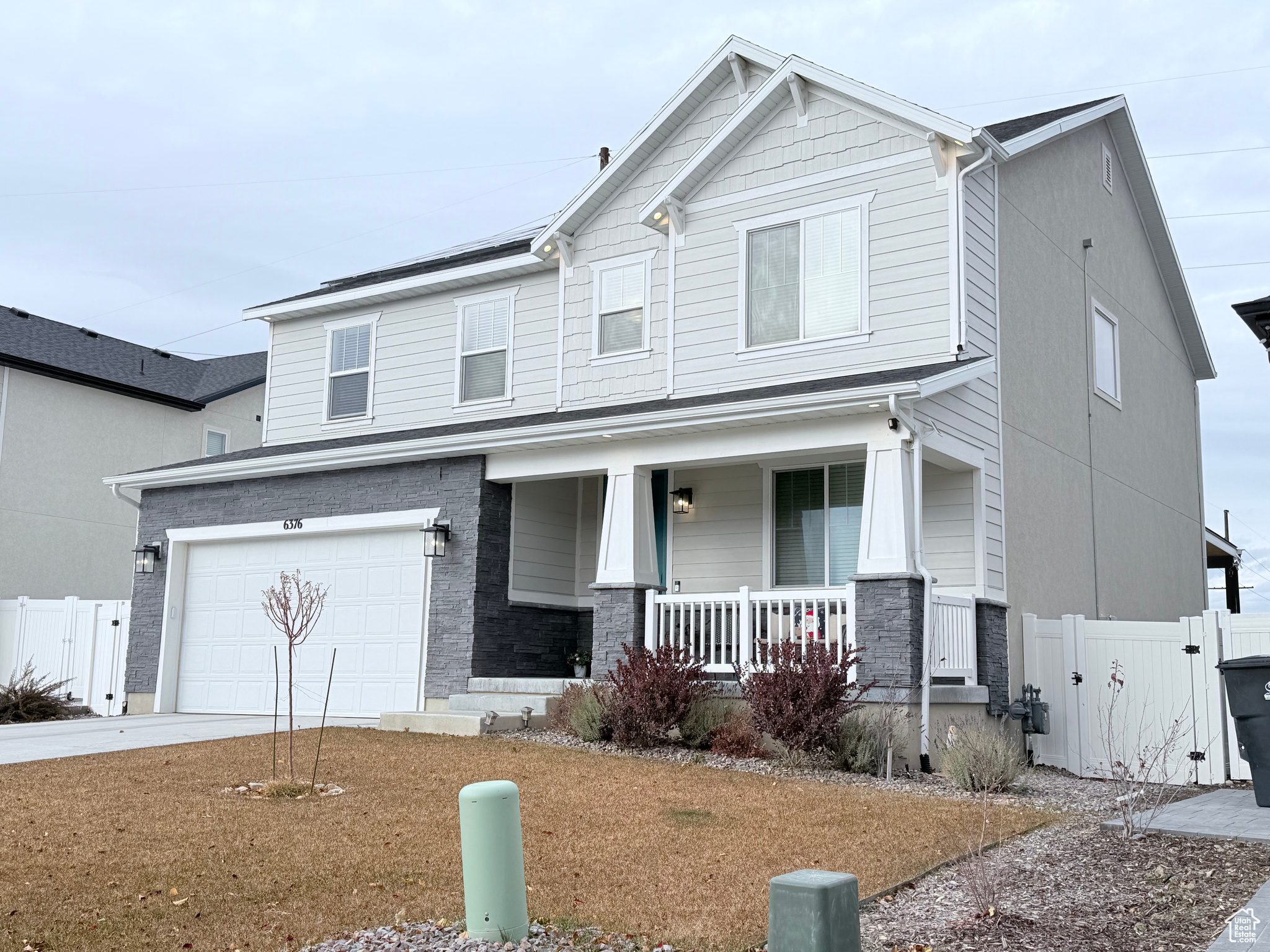 View of front of house with a porch and a garage