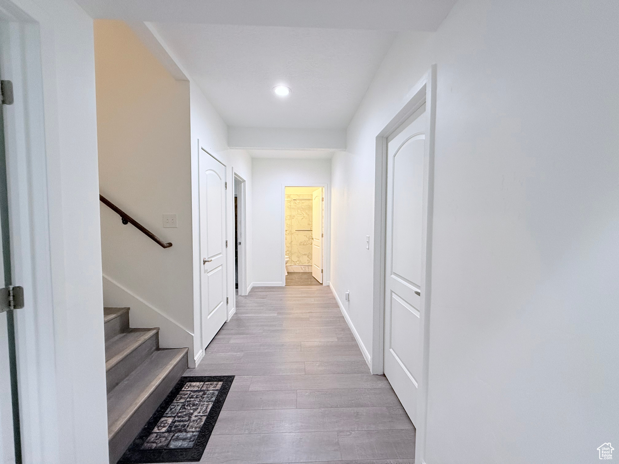 Hallway in basement leading to gym and bathroom