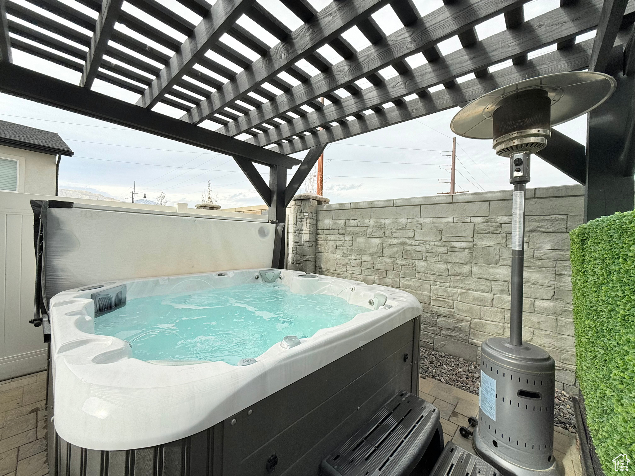 View of patio / terrace with a pergola and a hot tub. Hot tub is negotiable