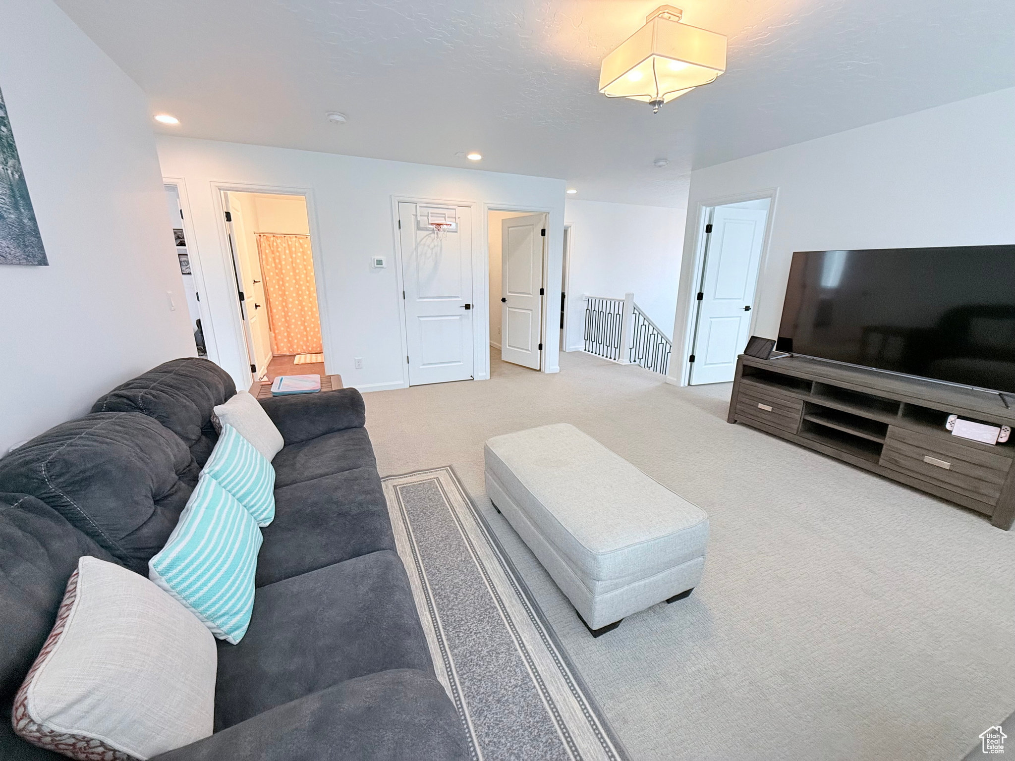 View of carpeted living room, bedrooms and bathroom on 2nd Floor