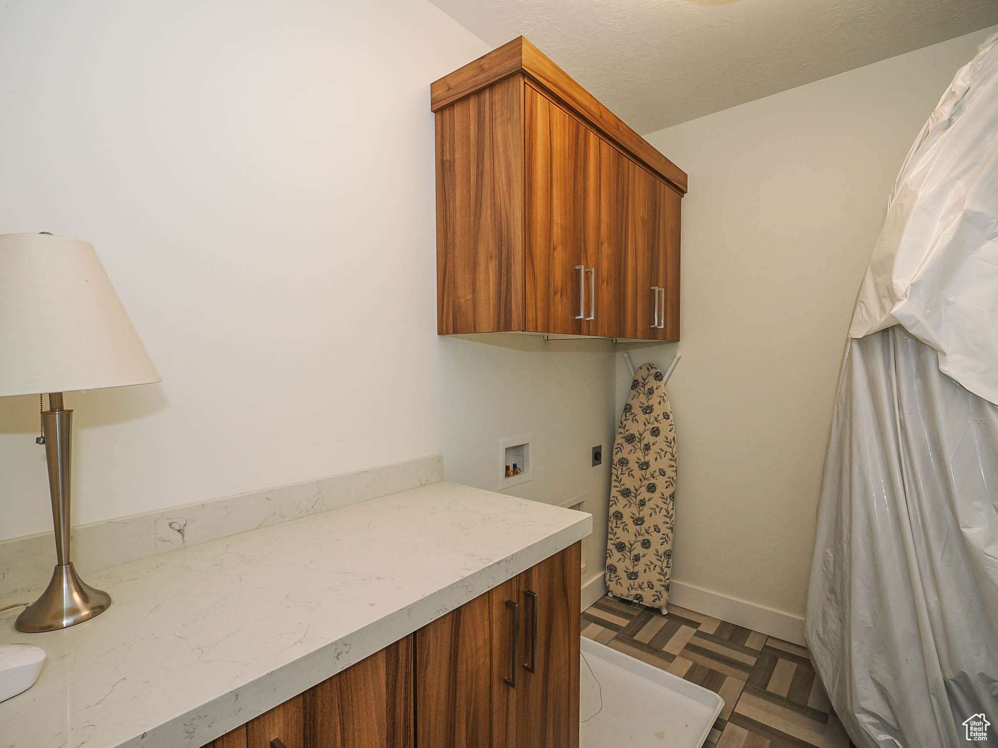 Laundry room featuring cabinets, washer hookup, dark parquet flooring, and hookup for an electric dryer
