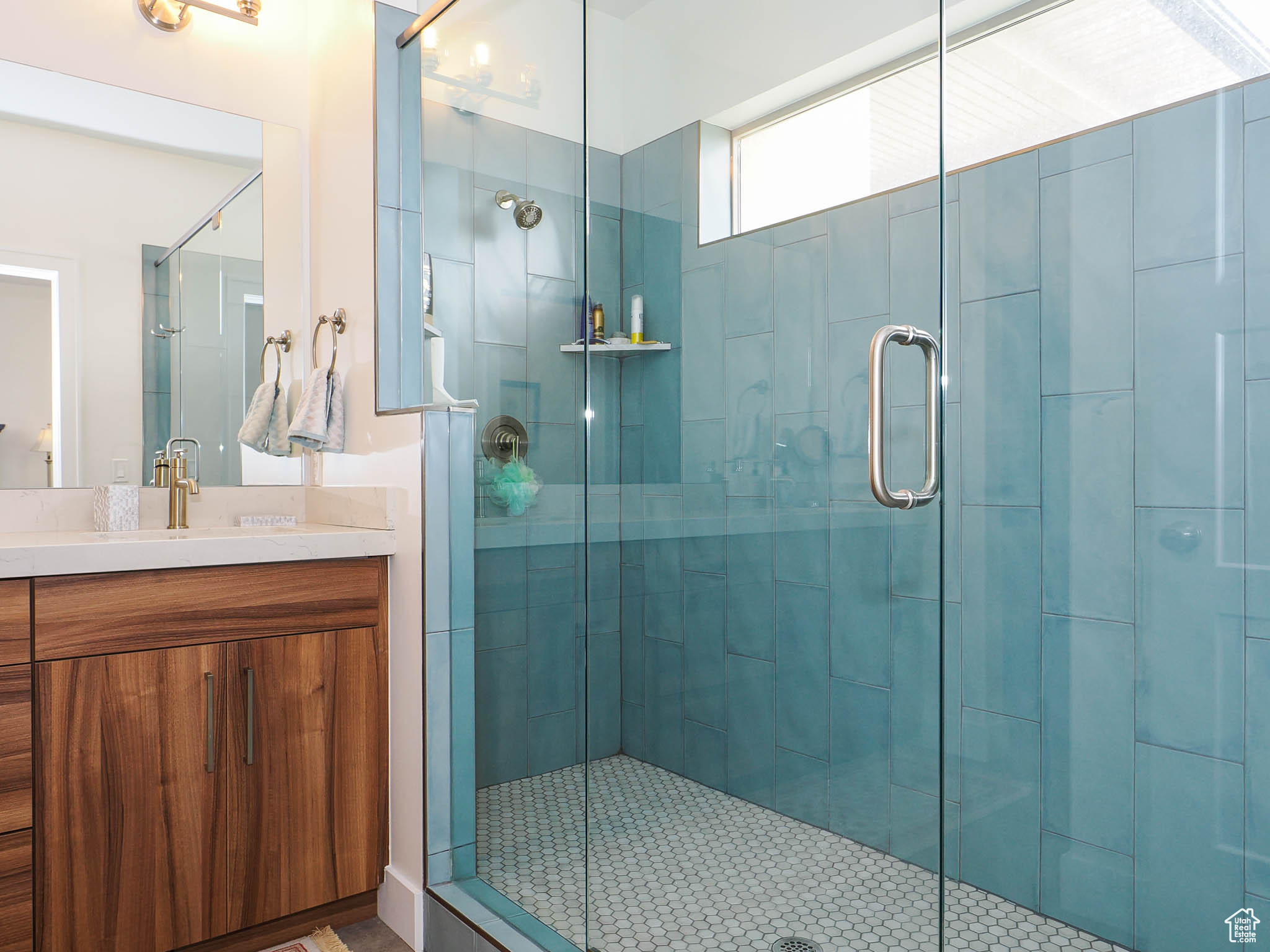 Mather Bathroom with tile patterned flooring, vanity, and a shower with shower door