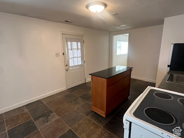 Kitchen featuring a kitchen island and stove