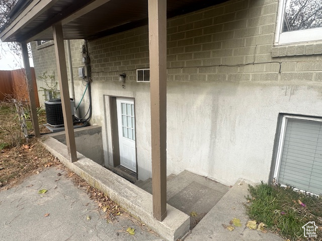 Property entrance featuring cooling unit