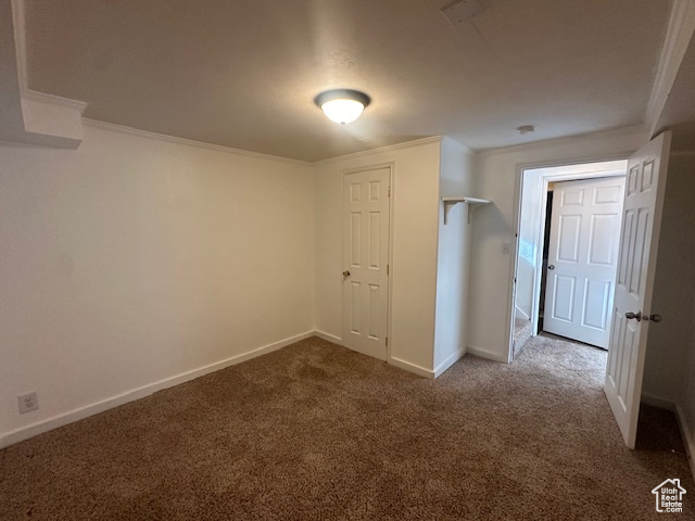 Interior space featuring crown molding and carpet floors