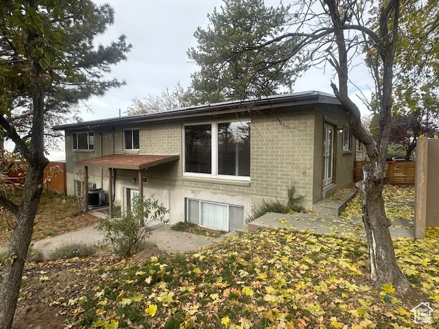 Back of property featuring a patio area and cooling unit