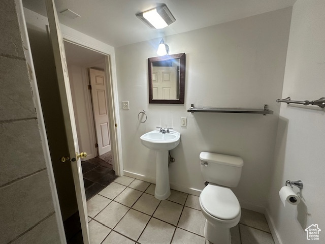 Bathroom featuring sink, tile patterned flooring, and toilet