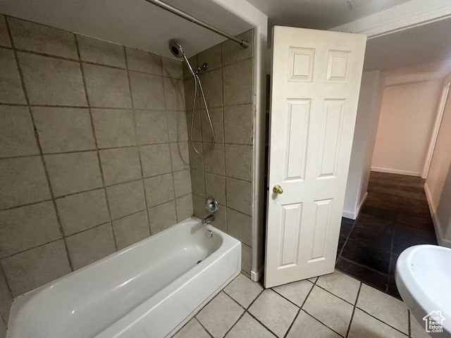 Bathroom with tile patterned flooring and tiled shower / bath