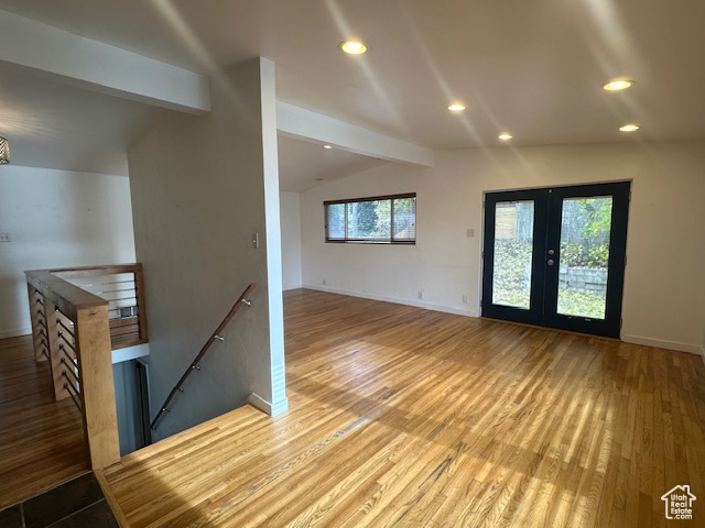 Interior space featuring hardwood / wood-style floors, lofted ceiling with beams, and french doors