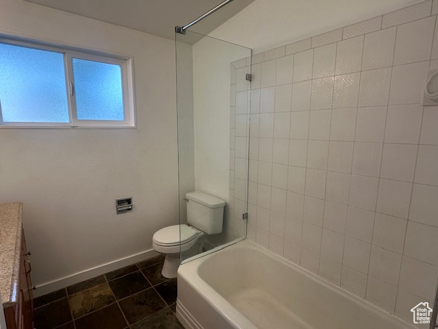 Full bathroom with tile patterned floors, vanity, toilet, and tiled shower / bath combo